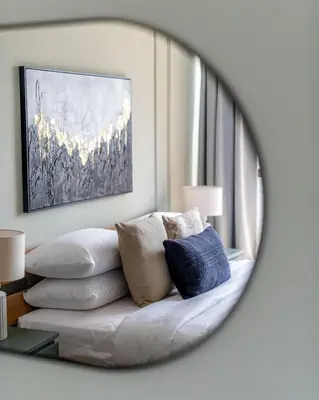 a mirror reflecting a couch in a living room at GuestReady - Marvellous getaway in Dubai Marina in Dubai