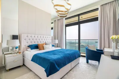 a bedroom with a bed and a large window at GuestReady - Blue Diamond Beachfront Retreat in Dubai