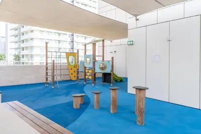 a childrens playground with benches and a slide at GuestReady - Blue Diamond Beachfront Retreat in Dubai