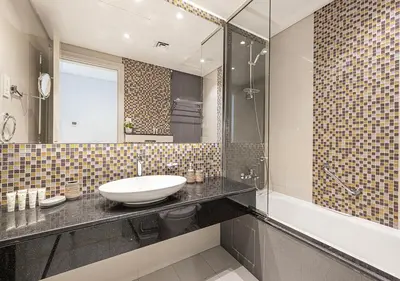a bathroom with a sink and a mirror and a tub at Burj Khalifa View! 2 Bedroom Luxe Apartment with 4 minute walk to Dubai Mall! Pool and Sauna Access! in Dubai