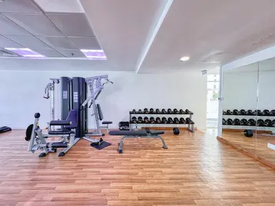 a gym with treadmills and machines in a room at ShoresInn - Serene Retreat with Waterfront Views in Dubai