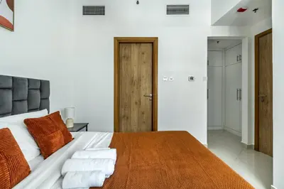 a bedroom with a large bed with towels on it at ShoresInn - Serene Retreat with Waterfront Views in Dubai