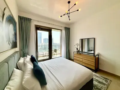 a bedroom with a large bed and a large window at Sparkle Tower Panoramic Marina View 1BR in Dubai