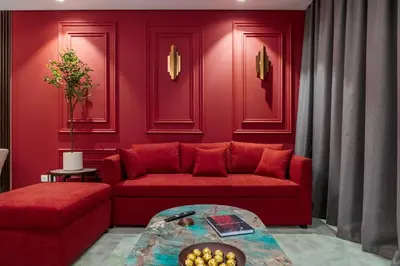 a living room with a red couch and a table at 5 Star Apartment with Burj View Infinity Pool and Gym Spa in Dubai