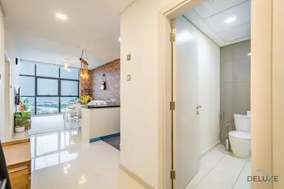 a large bathroom with a toilet and a sink at Premium 1BR at DAMAC Hills Loreto 1B in Dubailand by Deluxe Holiday Homes in Dubai