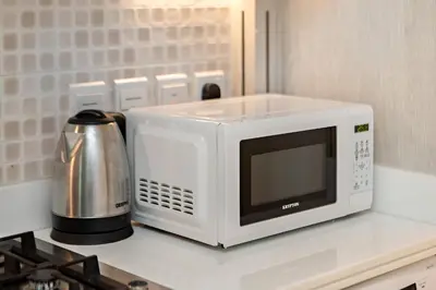 a microwave sitting on top of a kitchen counter at Modern and Cozy Studio at Seven Palm Prime Location in Dubai