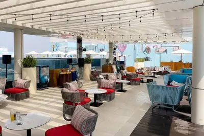 a restaurant with tables and chairs and tables and chairs at Modern and Cozy Studio at Seven Palm Prime Location in Dubai