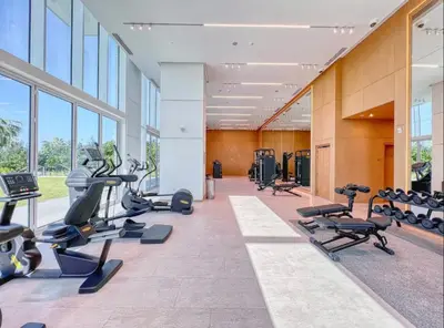 a gym with treadmills and cardio equipment in a building at La Vie Beach front JBR apartment by Happy Season in Dubai
