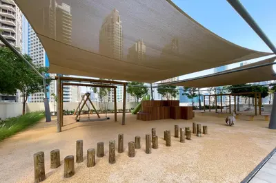 a building with a canopy with a playground and a swing at 1BR Burj Royale Near Dubai Mall Downtown in Dubai