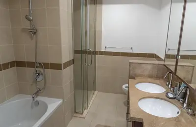 a bathroom with two sinks and a shower at Downtown Gem, Full Burj Khalifa & Dubai Fountain Views, Luxury Amenities in Dubai