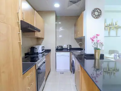 a small kitchen with a stove and a dishwasher at Vibrant 1 Bedroom at Barasti-Dubai Marina in Dubai