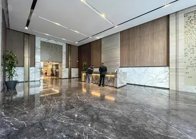 two people standing in the lobby of a building at Vibrant 1 Bedroom at Barasti-Dubai Marina in Dubai