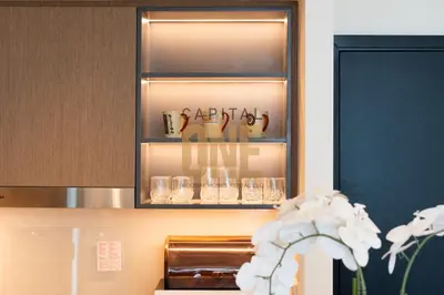 a cupboard with glasses in it with a shelf at Burj Khalifa View, Pool, Parking, 1BR, Downtown Dubai, Modern Furnished in Dubai
