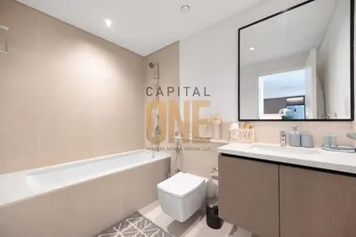 a bathroom with a tub and a toilet and a sink at Burj Khalifa View, Pool, Parking, 1BR, Downtown Dubai, Modern Furnished in Dubai