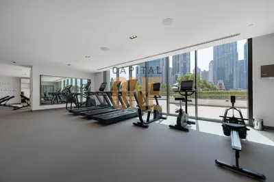 a gym with cardio machines and a large window at Burj Khalifa View, Pool, Parking, 1BR, Downtown Dubai, Modern Furnished in Dubai