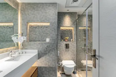 a bathroom with a shower and a toilet and a sink at Vacay Lettings - Spacious 3 Bedroom at JBR walk in Dubai