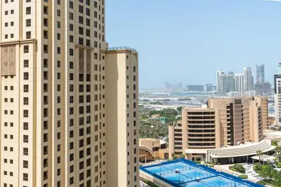 a view of two tall buildings in a city at Vacay Lettings - Spacious 3 Bedroom at JBR walk in Dubai