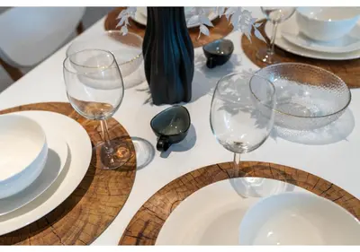 a table with wine glasses and plates on it at Trendy & Cozy 1BR Midtown 20 mins to Expo City by Vibel in Dubai