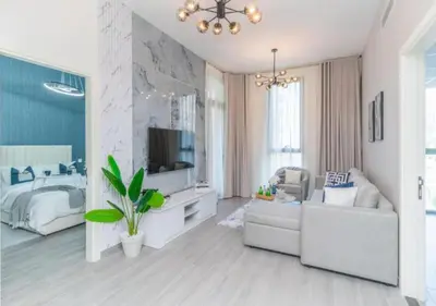 a living room with a couch and a television at Classy 1BR in Midtown Access All Dubai Spots by Vibel in Dubai