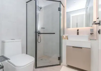 a bathroom with a shower and a toilet and a sink at Classy 1BR in Midtown Access All Dubai Spots by Vibel in Dubai