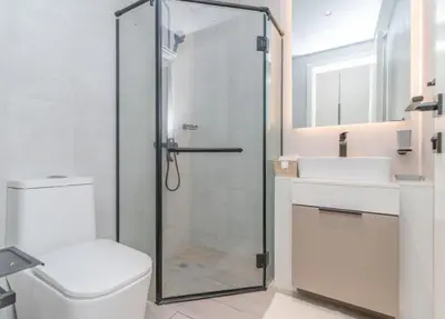 a bathroom with a shower and a toilet and a sink at Classy 1BR Midtown Stay Near Miracle Garden by Vibel in Dubai