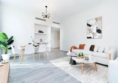 a living room with a couch and a table at Cozy 2BR Near Dubai Spots Midtown Dubai Access by Vibel in Dubai
