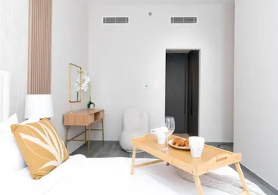 a living room with a bed and a coffee table at Cozy 2BR Near Dubai Spots Midtown Dubai Access by Vibel in Dubai