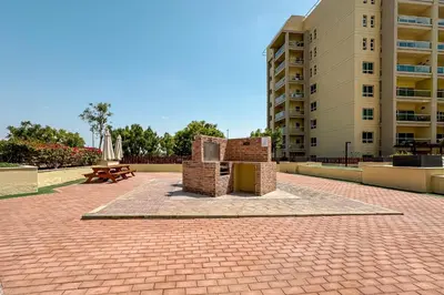 a brick courtyard with a monument in front of a building at 1BR The Greens Courtyard View in Dubai