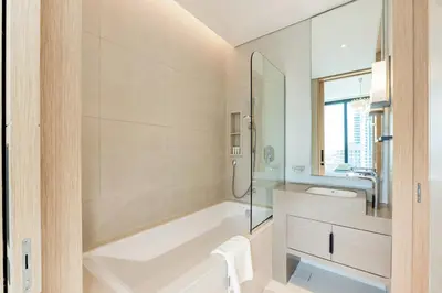 a white bathroom with a tub and a sink at Luxury at JBR Jumeirah Gate Tower 1 1 Bed in Dubai