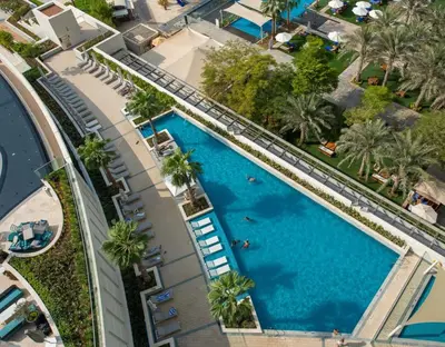 an overhead view of a large swimming pool with palm trees at Luxury at JBR Jumeirah Gate Tower 1 1 Bed in Dubai