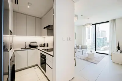 a kitchen with white cabinets and a large window at Luxury at JBR Jumeirah Gate Tower 1 1 Bed in Dubai