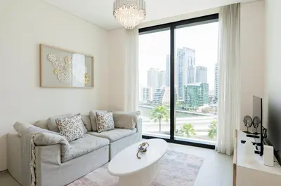 a living room with a couch and a large window at Luxury at JBR Jumeirah Gate Tower 1 1 Bed in Dubai