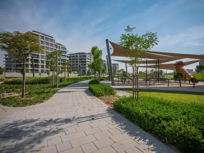 a walkway in a park with a playground at Dubai Hills Elegant 1-Bed with Terrace in Dubai