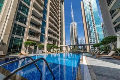 a swimming pool in a city with tall buildings at Downtown 1 Bed - Burj Khalifa Balcony View in Dubai