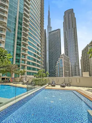 a swimming pool in the middle of a city with tall buildings at Prime Downtown Burj Khalifa I Sleeps 8 in Dubai