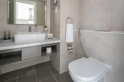 a bathroom with a white toilet and a sink at Frank Porter - Damac Maison Prive B in Dubai