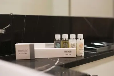 three bottles of essential oils sitting on a counter at Millennium Binghatti Residence 2BR Burj Khalifa and Lake in Dubai