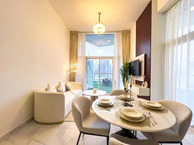 a living room with a table and chairs and a couch at Millennium Binghatti Residence 2BR Burj Khalifa and Lake in Dubai