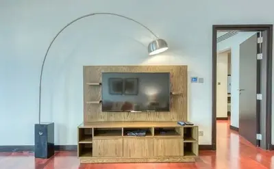 a living room with a flat screen tv on a entertainment center at Luxury Holiday Home, Spacious 1 bedroom, Burj Alarab full ocean view, located in Anantara the palm, Palm Jumeirah, Dubai in Dubai