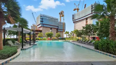 a swimming pool with chairs and a building at Brand new Business Bay location in Dubai