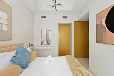 a bedroom with a white bed and a mirror at Brand new Business Bay location in Dubai