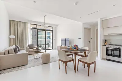 a kitchen and living room with a table and chairs at Silkhaus Marina View 1BDR Marina Vista Tower in Dubai