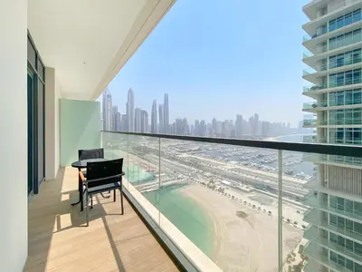 a balcony with a desk and a view of the city at Silkhaus Marina View 1BDR Marina Vista Tower in Dubai
