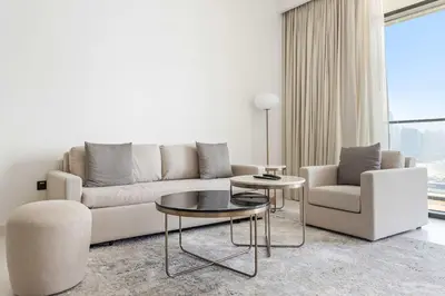 a living room with a couch and two chairs and a table at Silkhaus Marina View 1BDR Marina Vista Tower in Dubai