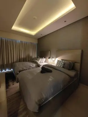 a hotel room with two beds in a bedroom at 2BR Tower D Paramount Apartment in Dubai