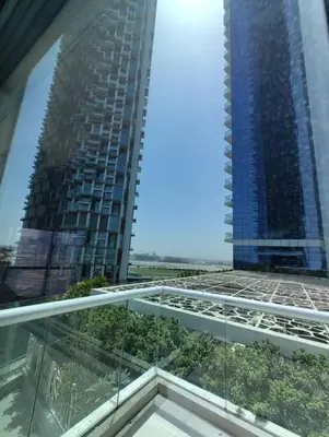 a view of a building from a glass balcony at 2BR Tower D Paramount Apartment in Dubai