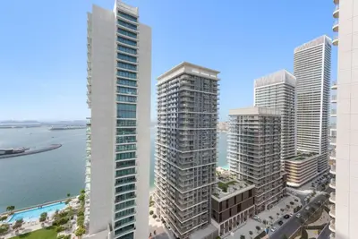 a group of tall buildings next to the water at Silkhaus 1BDR with Private Beach Marina Vista in Dubai