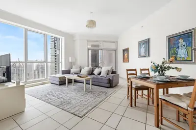 a living room with a couch and a table at 2BR Torch Tower High Floor Dubai Marina in Dubai