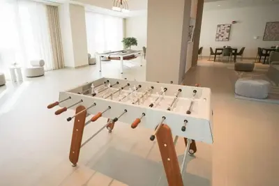 a large foosball table in a living room at 3BR Burj Khalifa Fountain Views Forte 1- 18th floor in Dubai