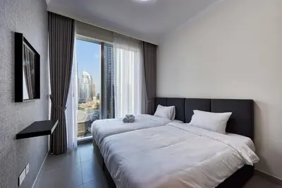 a bedroom with a large bed and a large window at 3BR Burj Khalifa Fountain Views Forte 1- 18th floor in Dubai